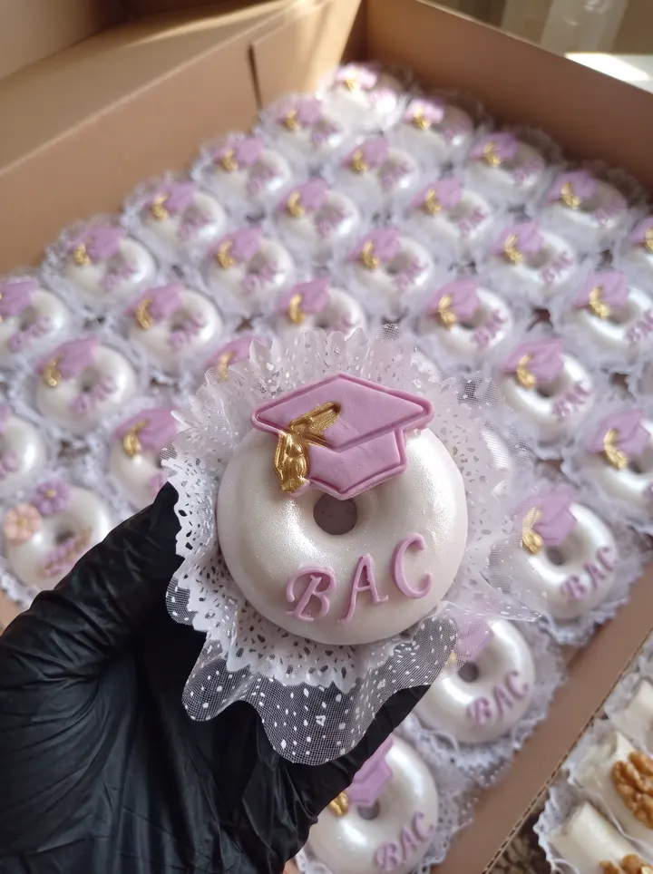 يد تحمل دونات النجاح BAC